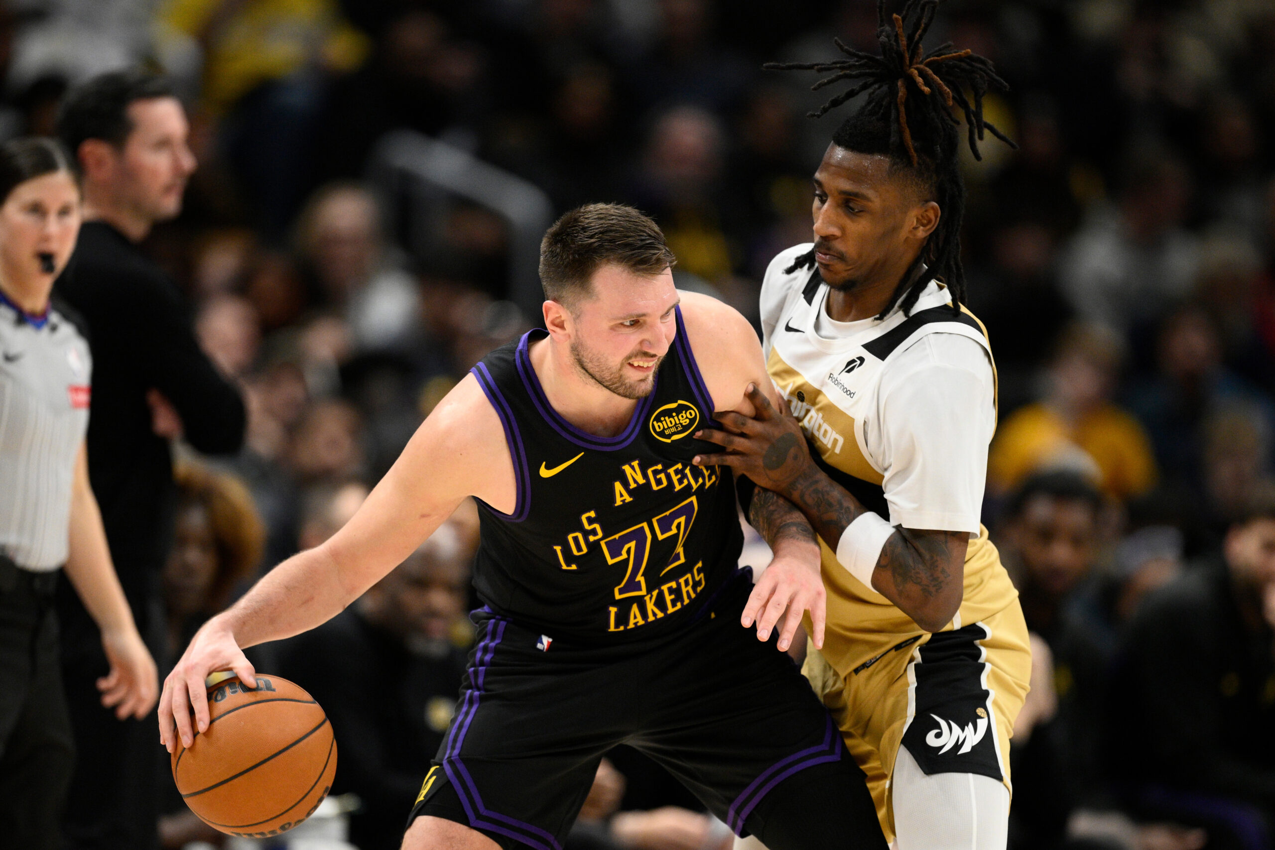 Lakers star Luka Doncic dribbles against Washington Wizards guard Jamir...