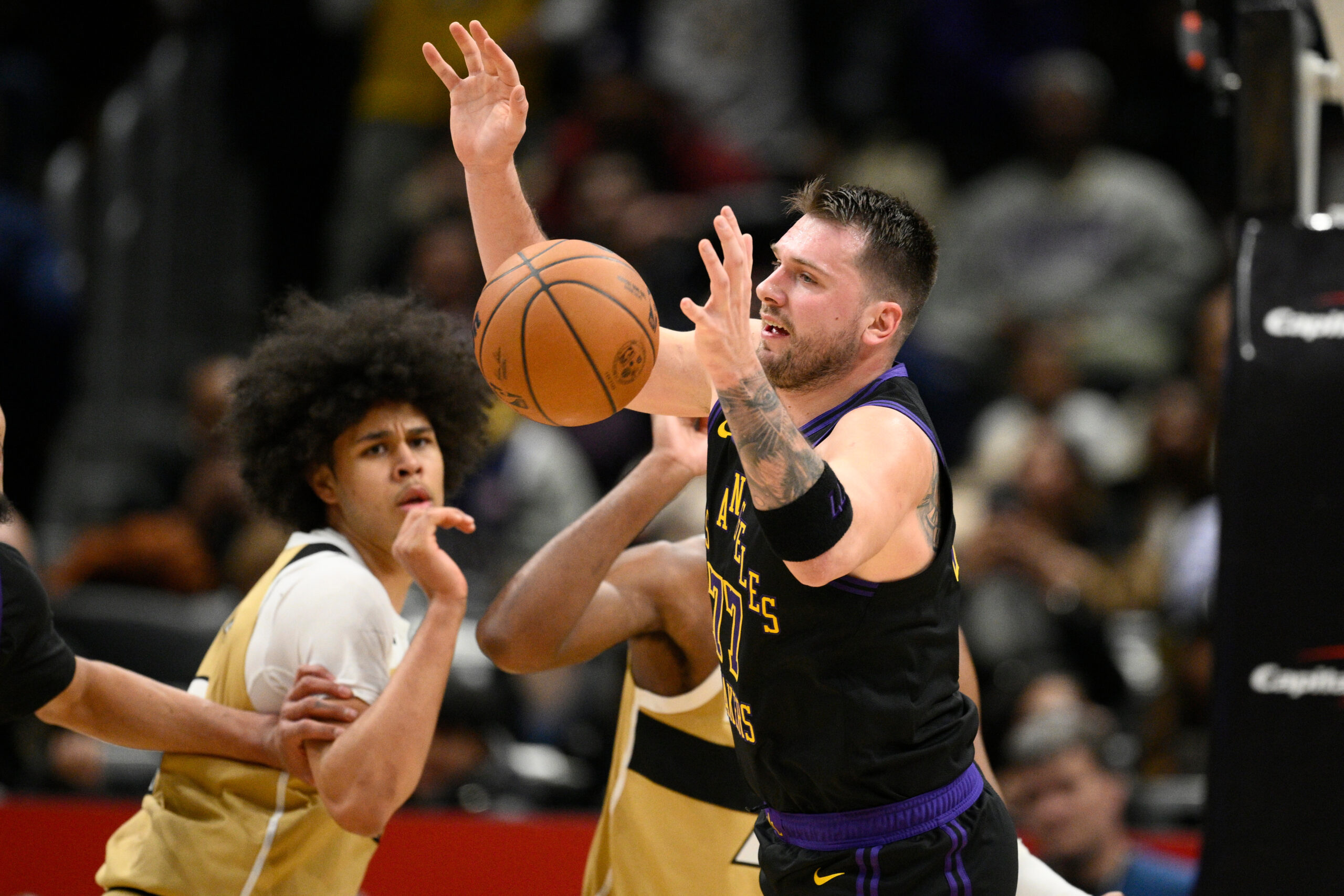 Lakers star Luka Doncic, right, chases the ball during the...
