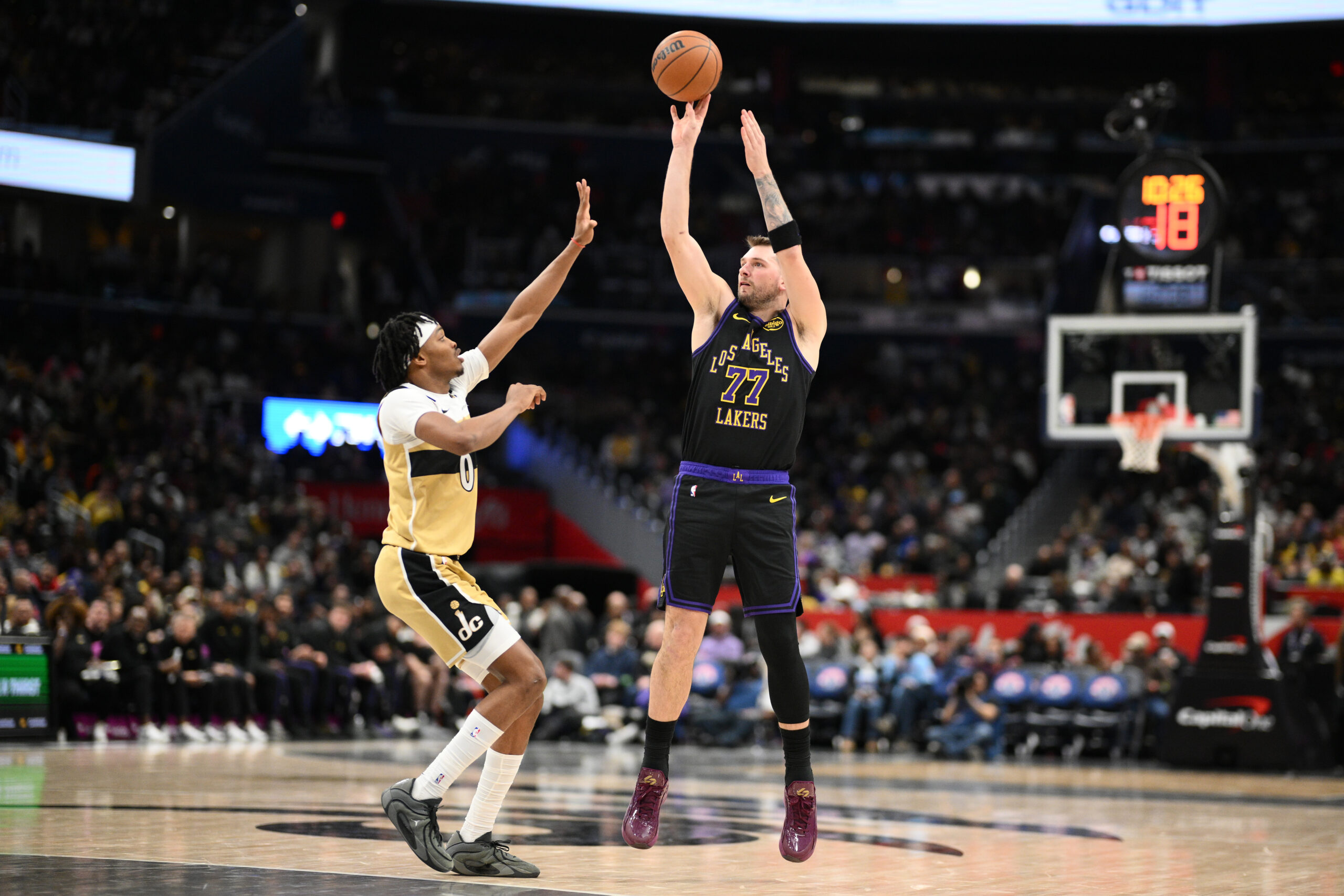 Lakers star Luka Doncic (77) shoots against Washington Wizards guard...