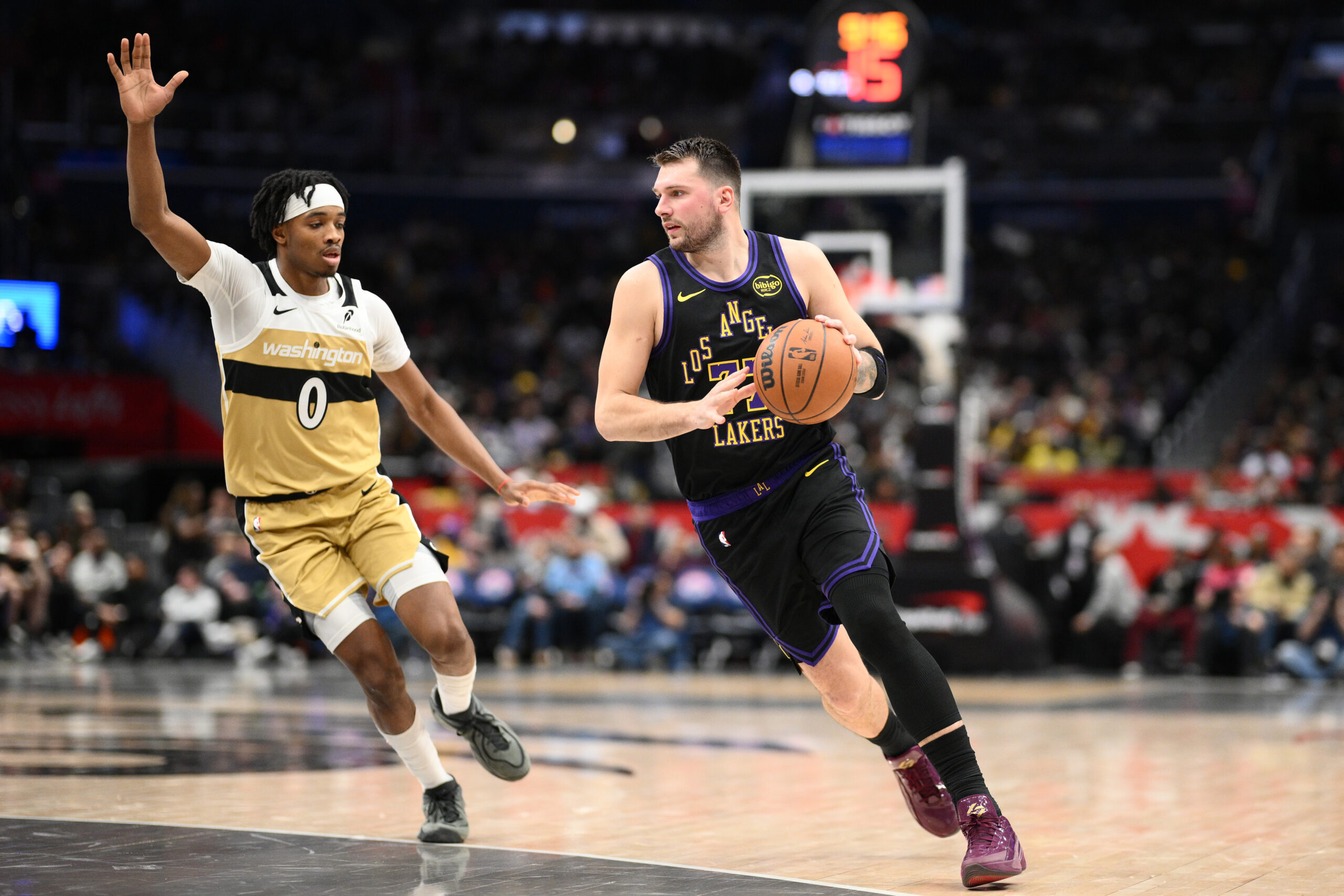 Lakers star Luka Doncic (77) drives to the basket against...