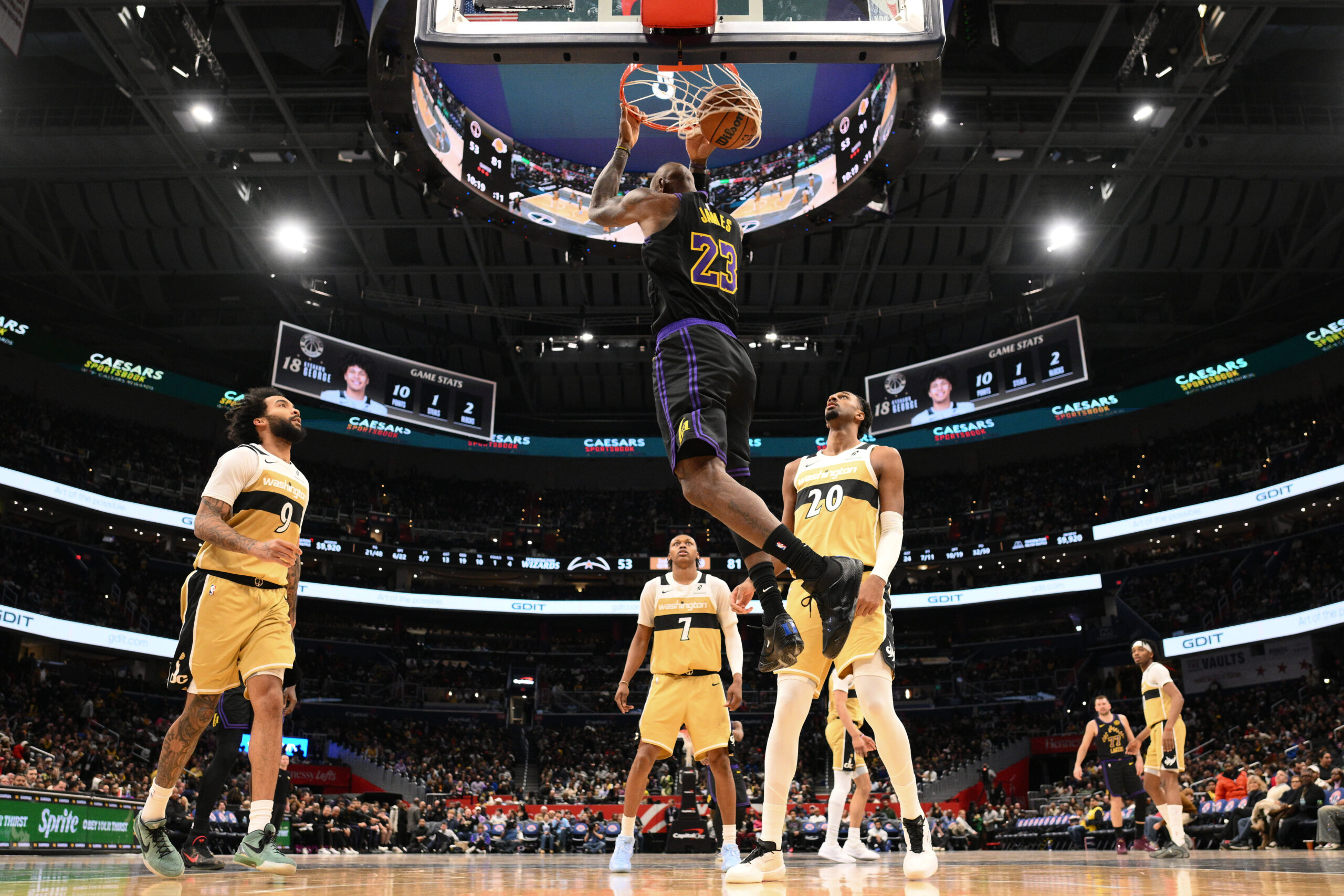 Lakers forward LeBron James (23) does a reverse dunk against...