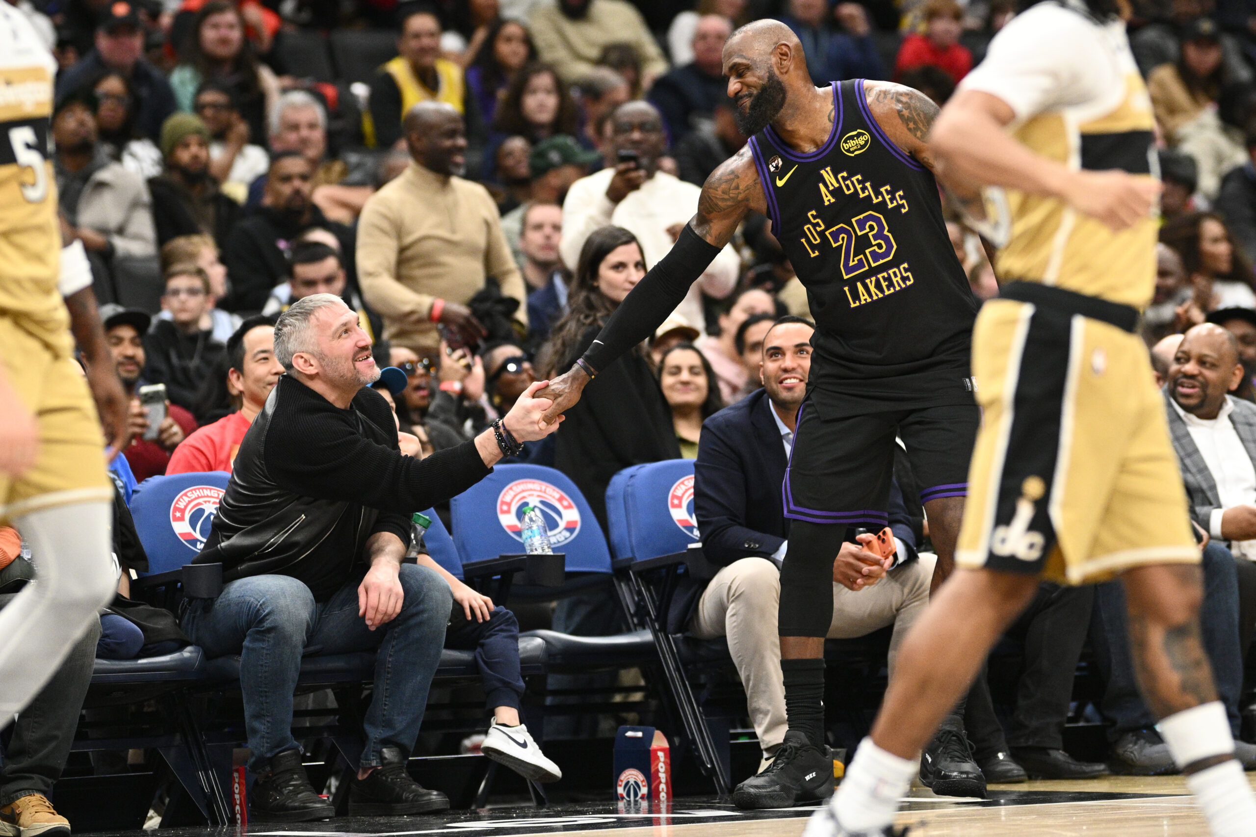 Lakers star LeBron James (23) shakes hands with Washington Capitals...