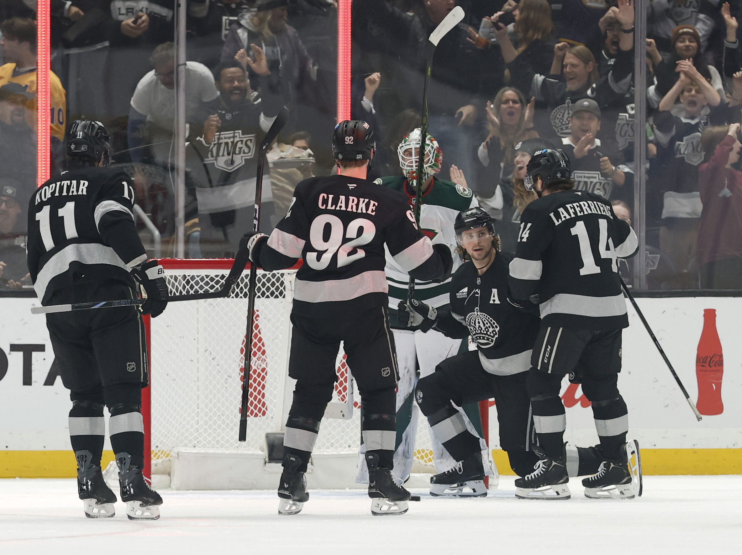 The Kings’ Adrian Kempe (9) celebrates his goal with Alex...