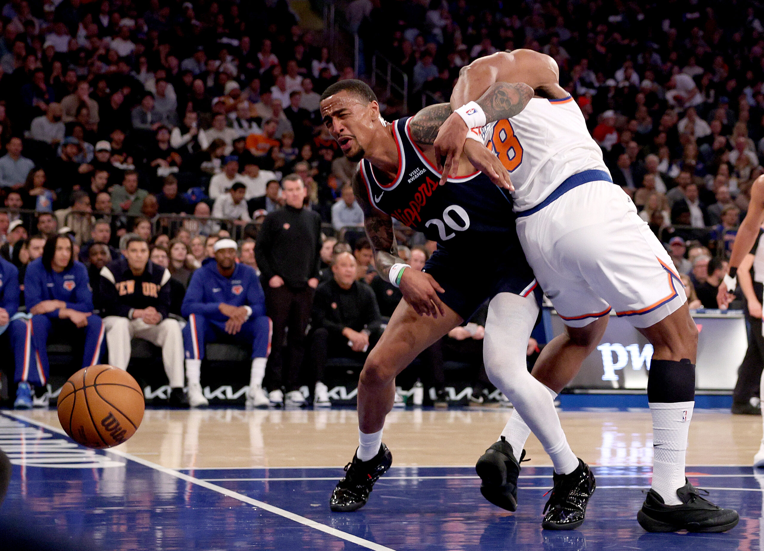Clippers forward John Collins, left, and the New York Knicks’...
