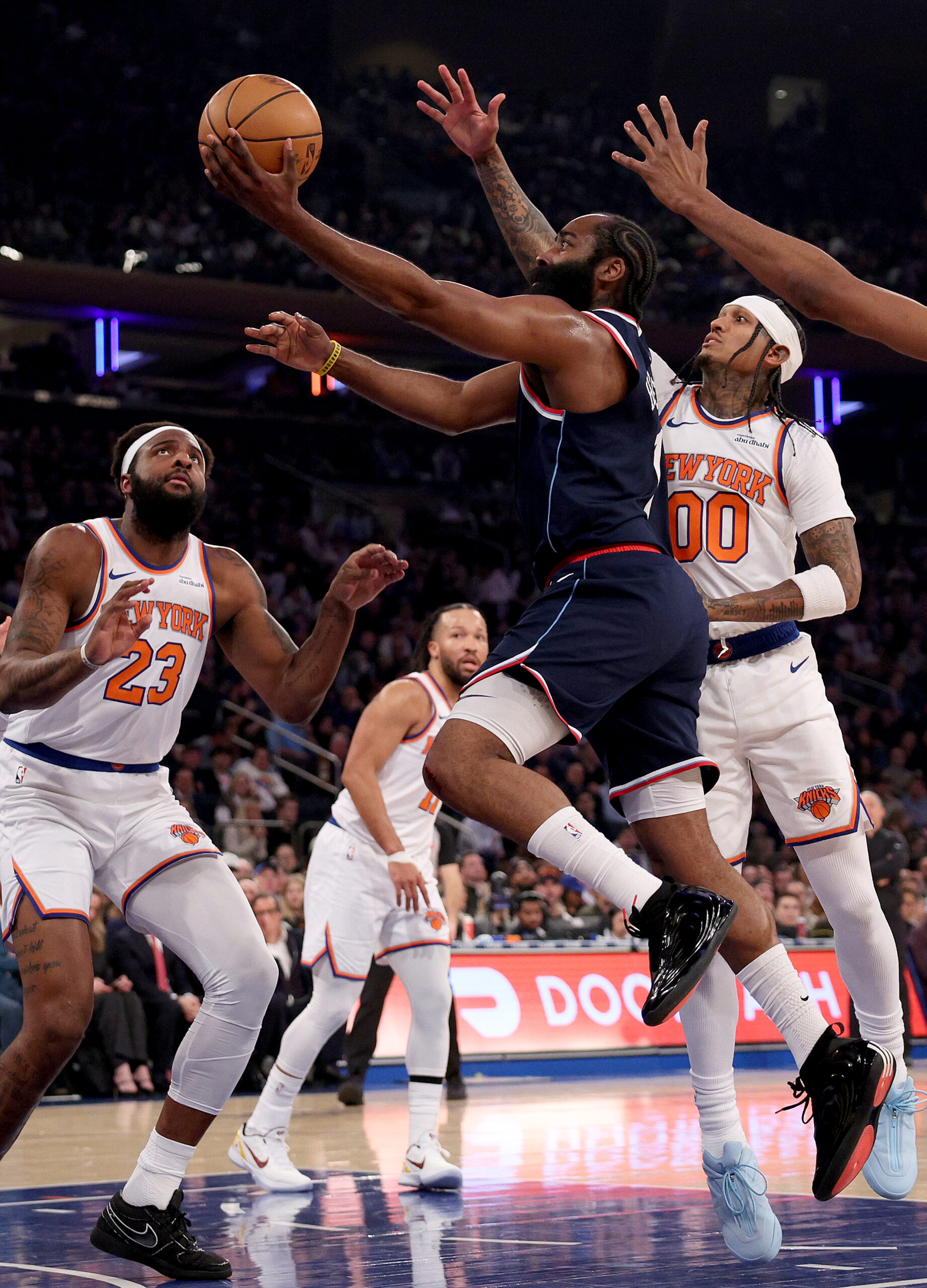 Clippers star James Harden heads for the basket as New...