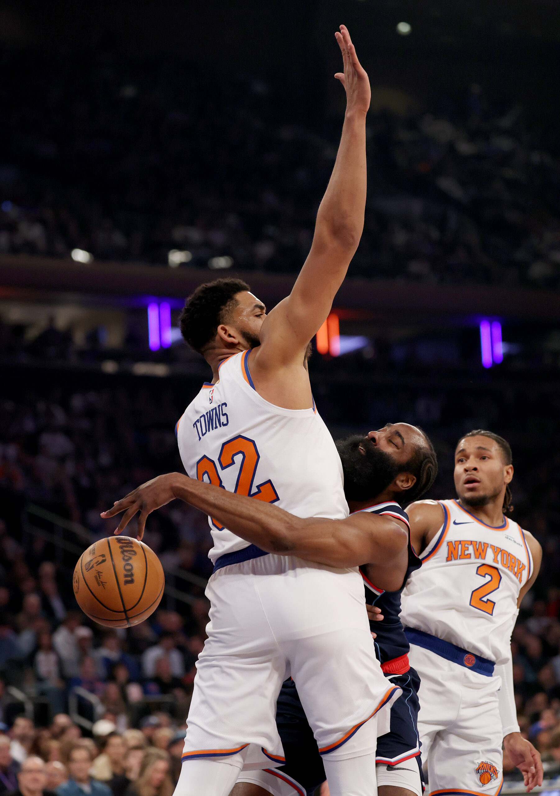 Clippers star James Harden, middle, collides with New York Knicks...