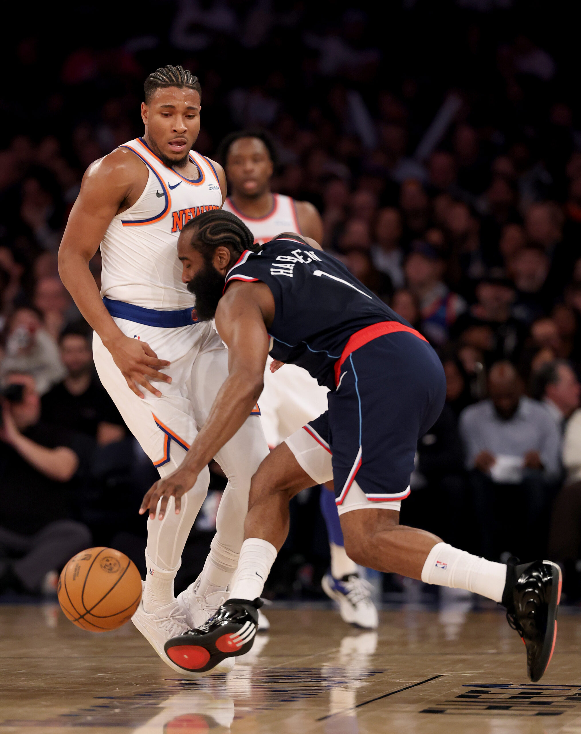 Clippers star James Harden, right, collides with the New York...