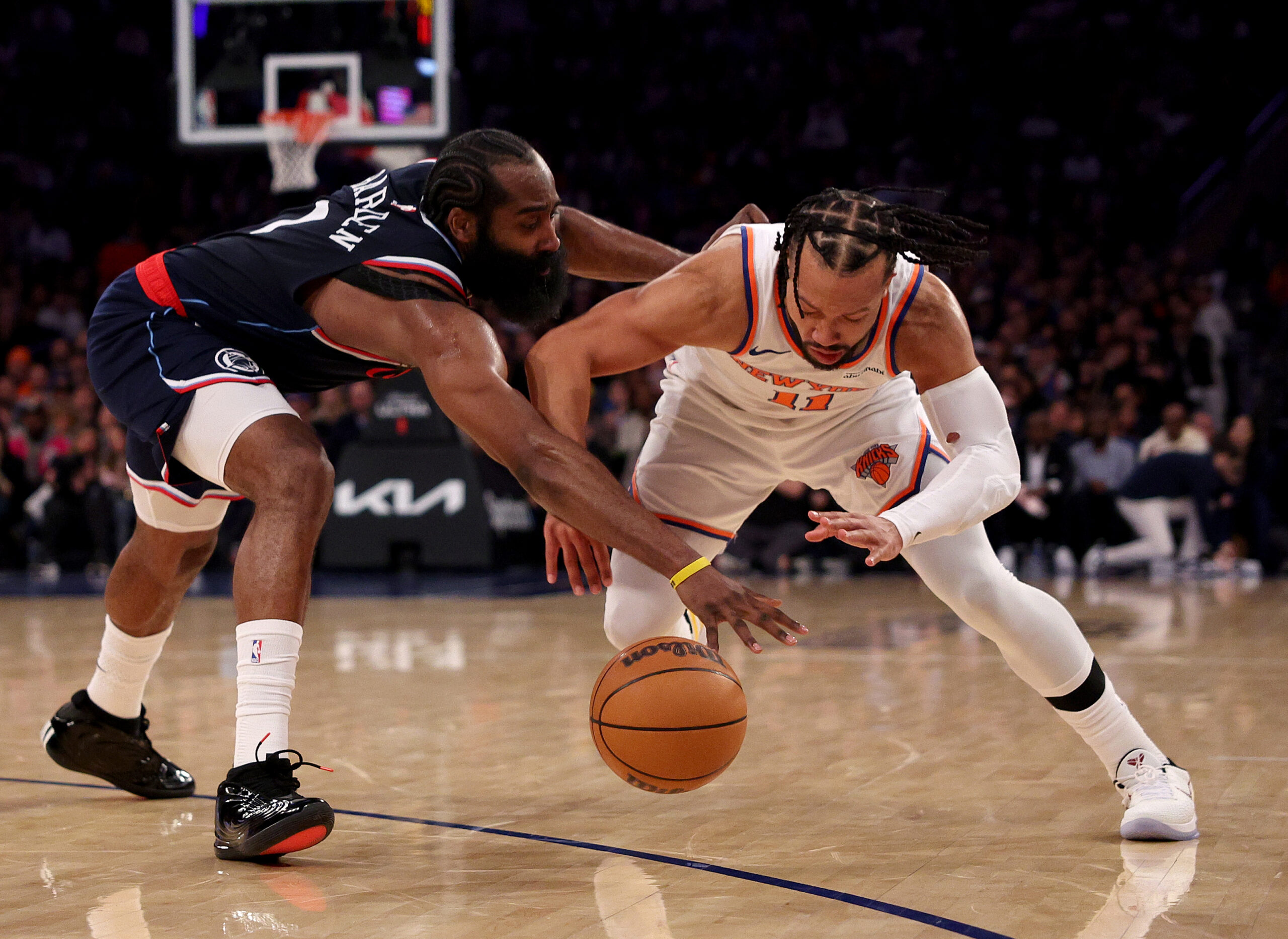 New York Knicks guard Jalen Brunson, right, tries to control...
