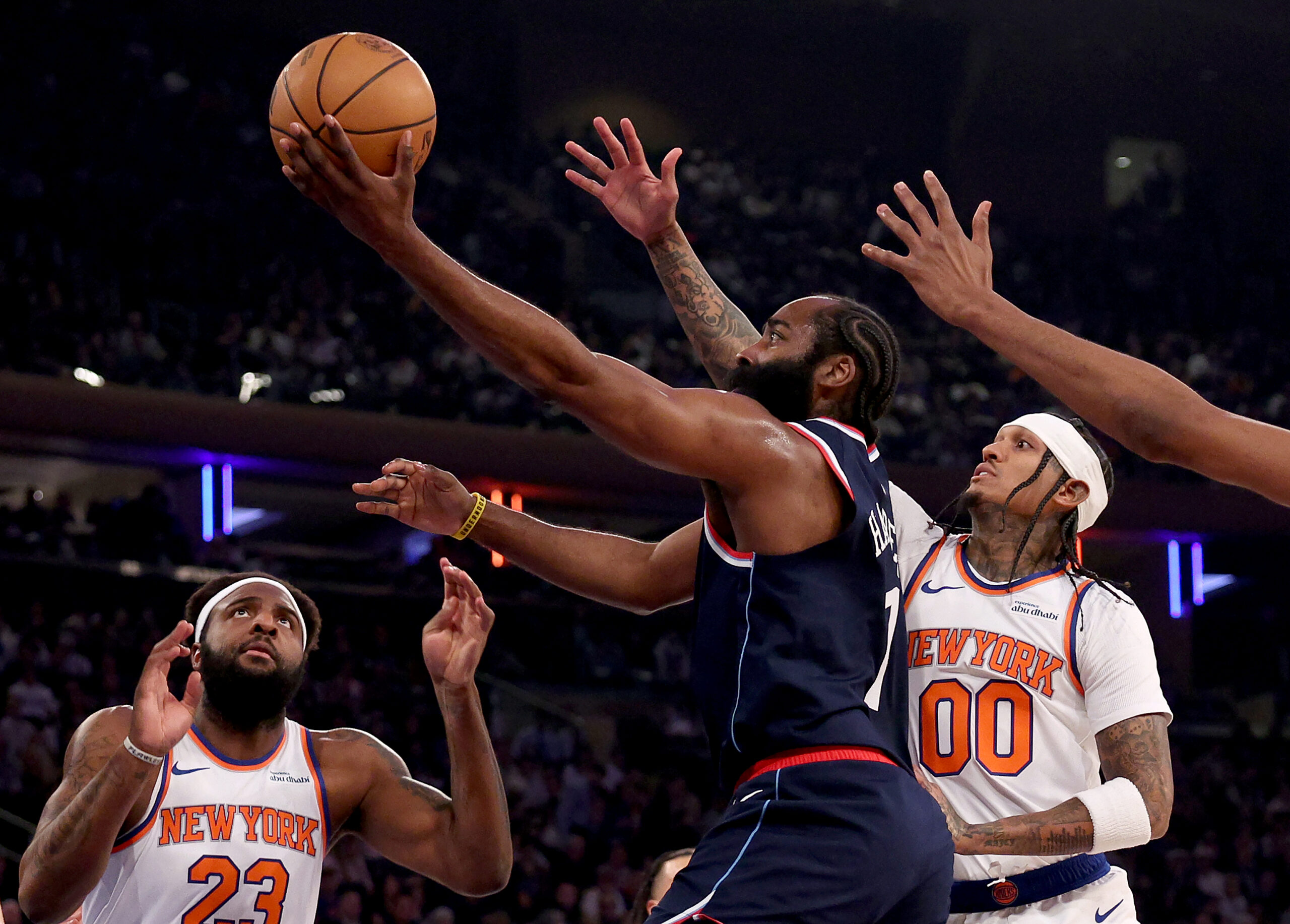 Clippers star James Harden heads for the basket as New...