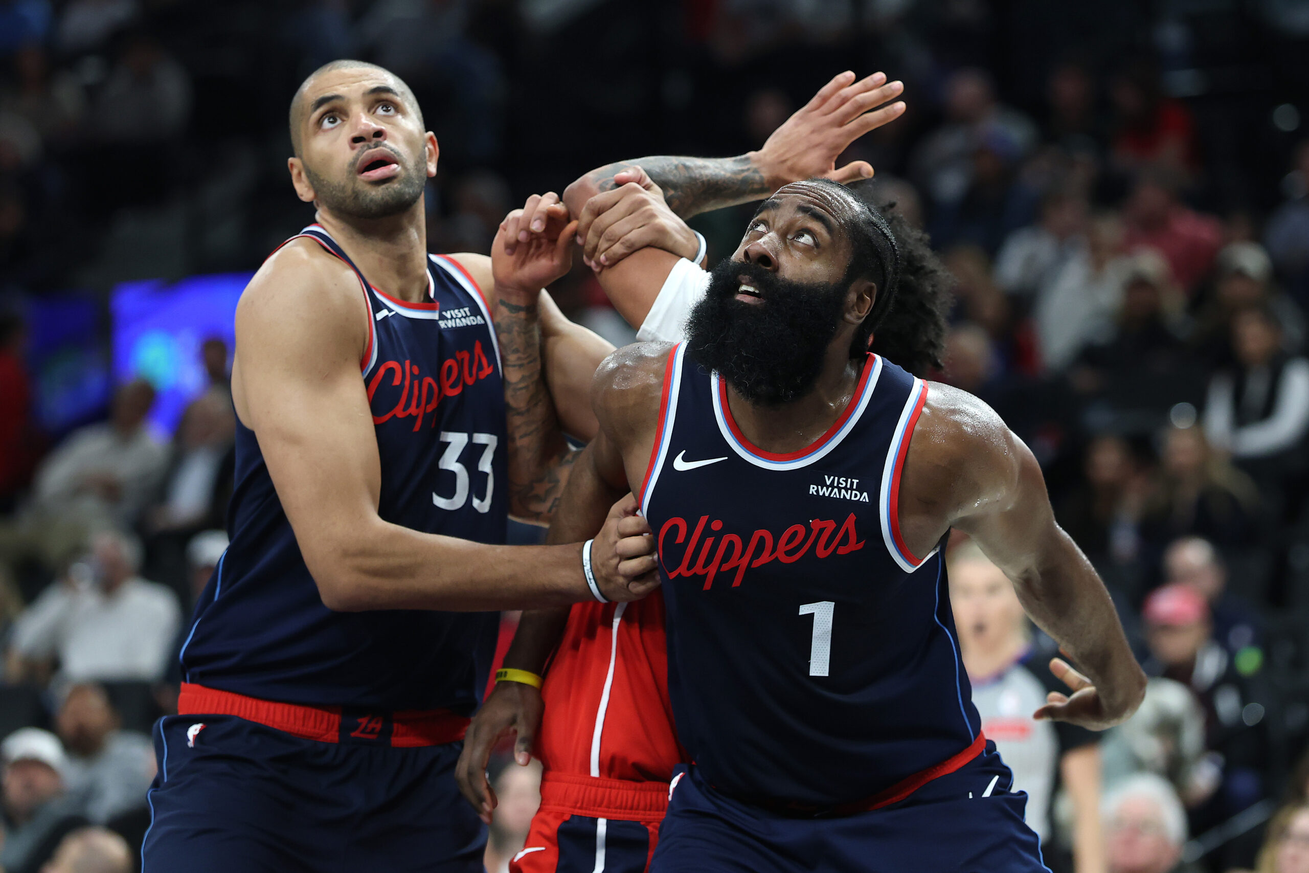 The Clippers’ Nicolas Batum, left, and James Harden, right, box...