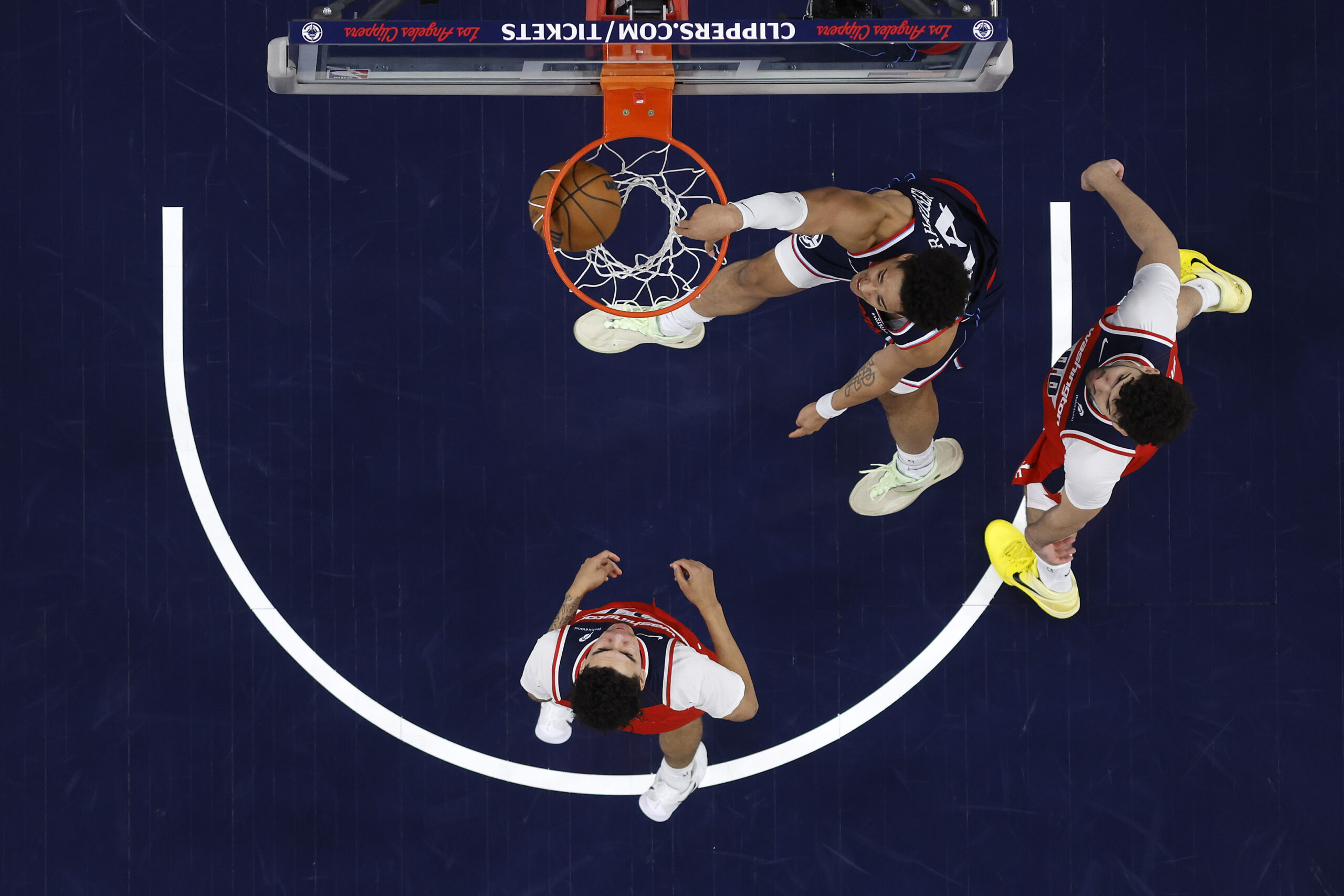 Clippers rookie center Yanic Konan Niederhauser, top, dunks in front...