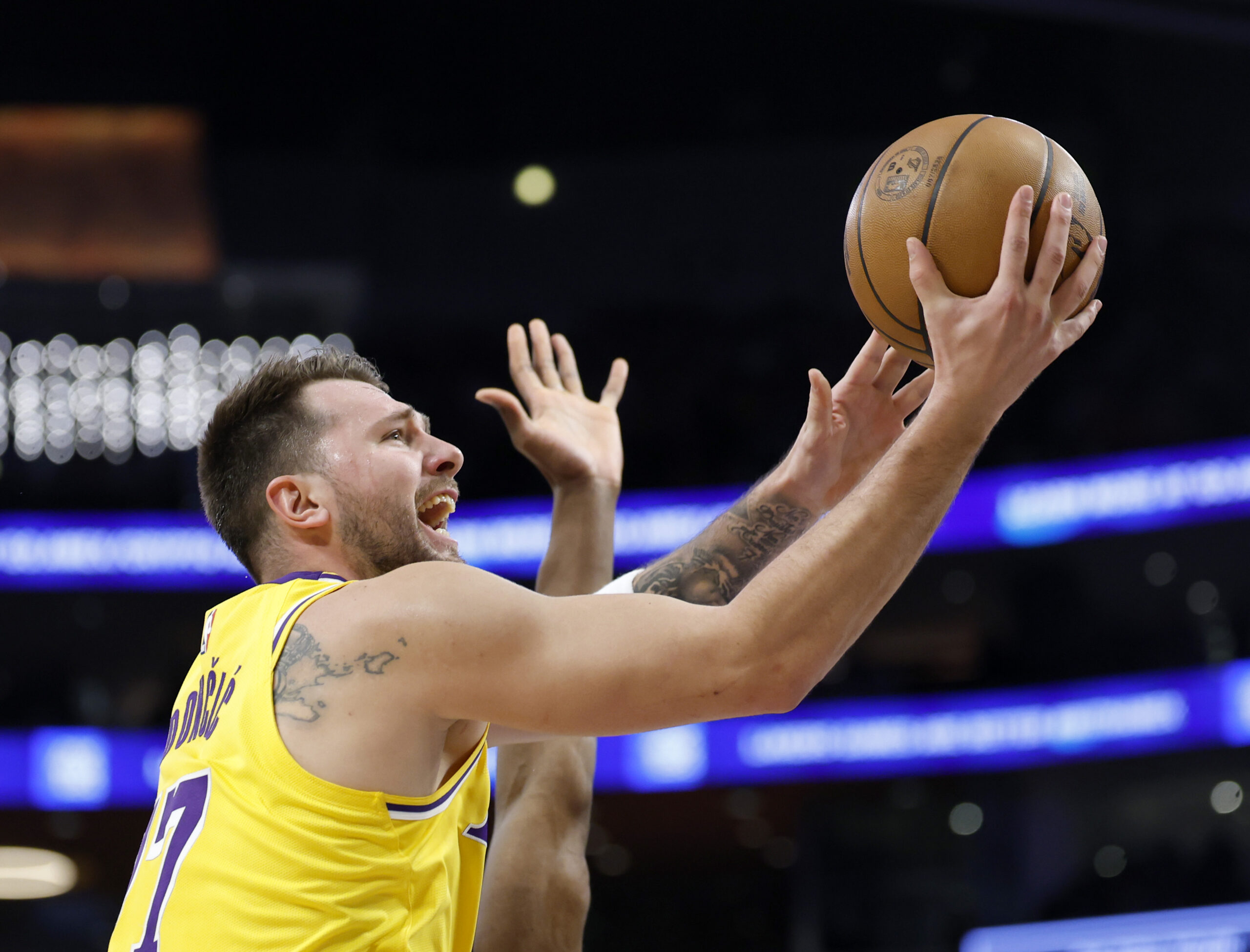 Lakers star Luka Doncic scores on a layup during the...