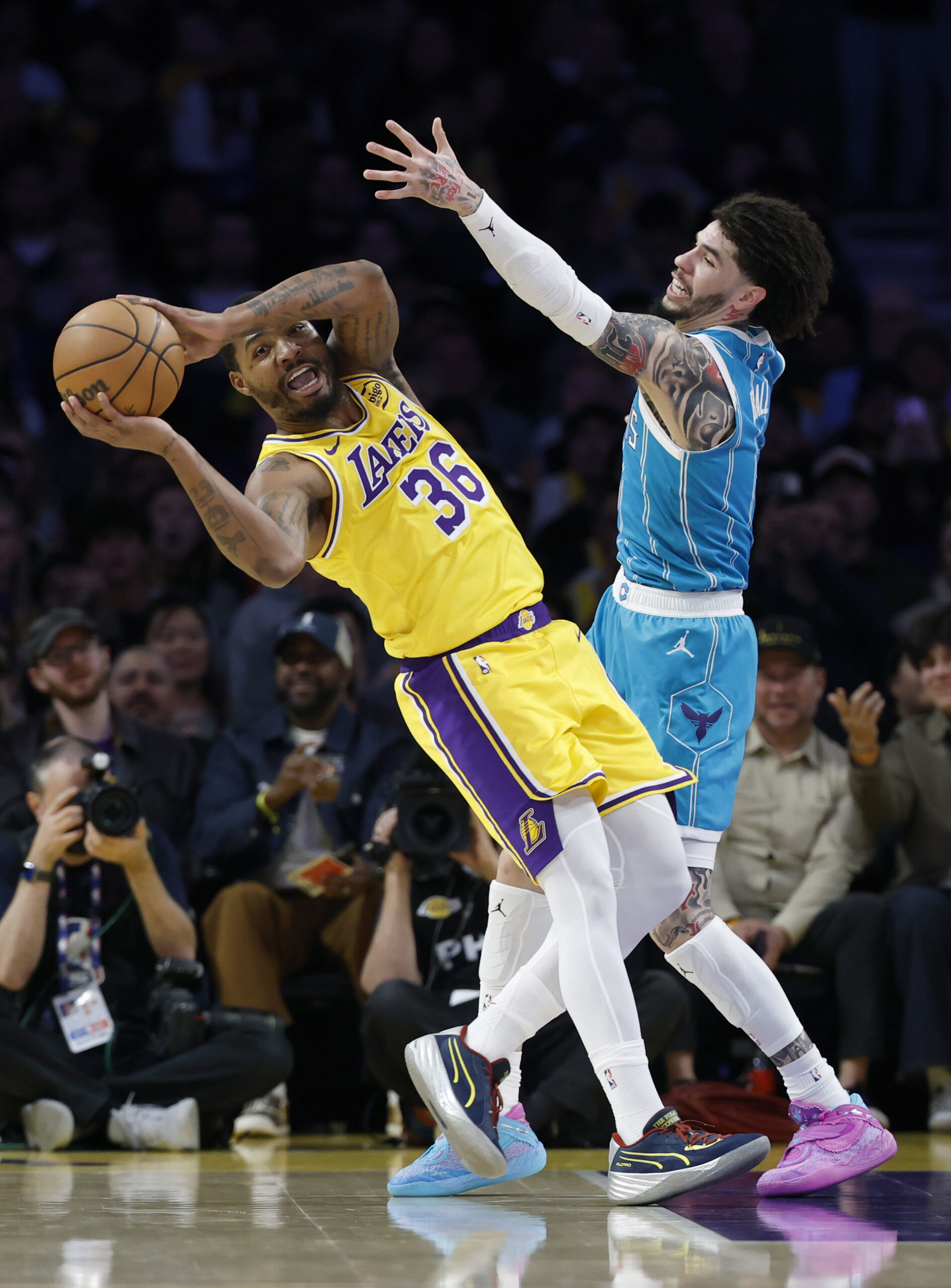 Lakers guard Marcus Smart, left, reacts as he grabs a...