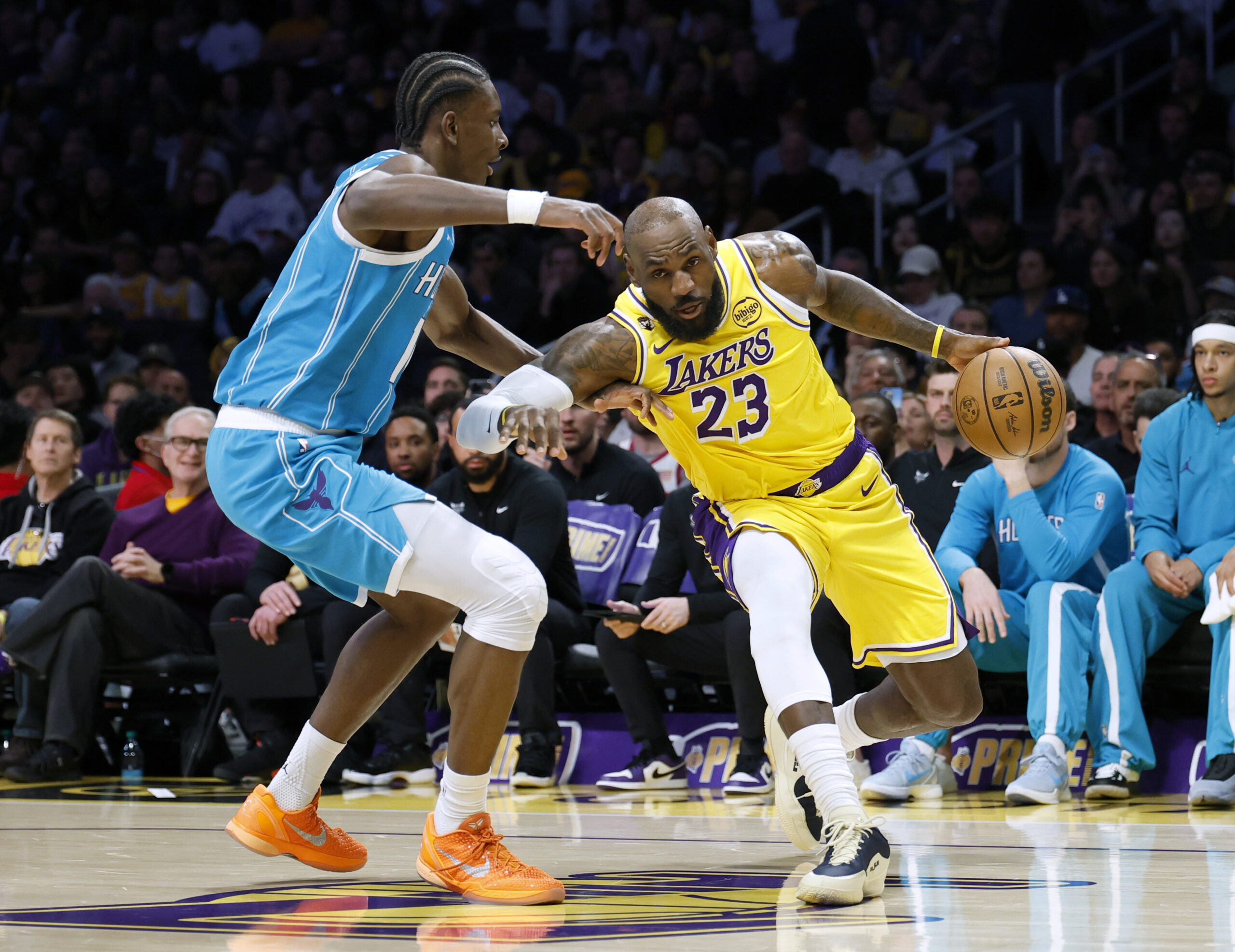 Lakers star LeBron James drives to the basket in front...