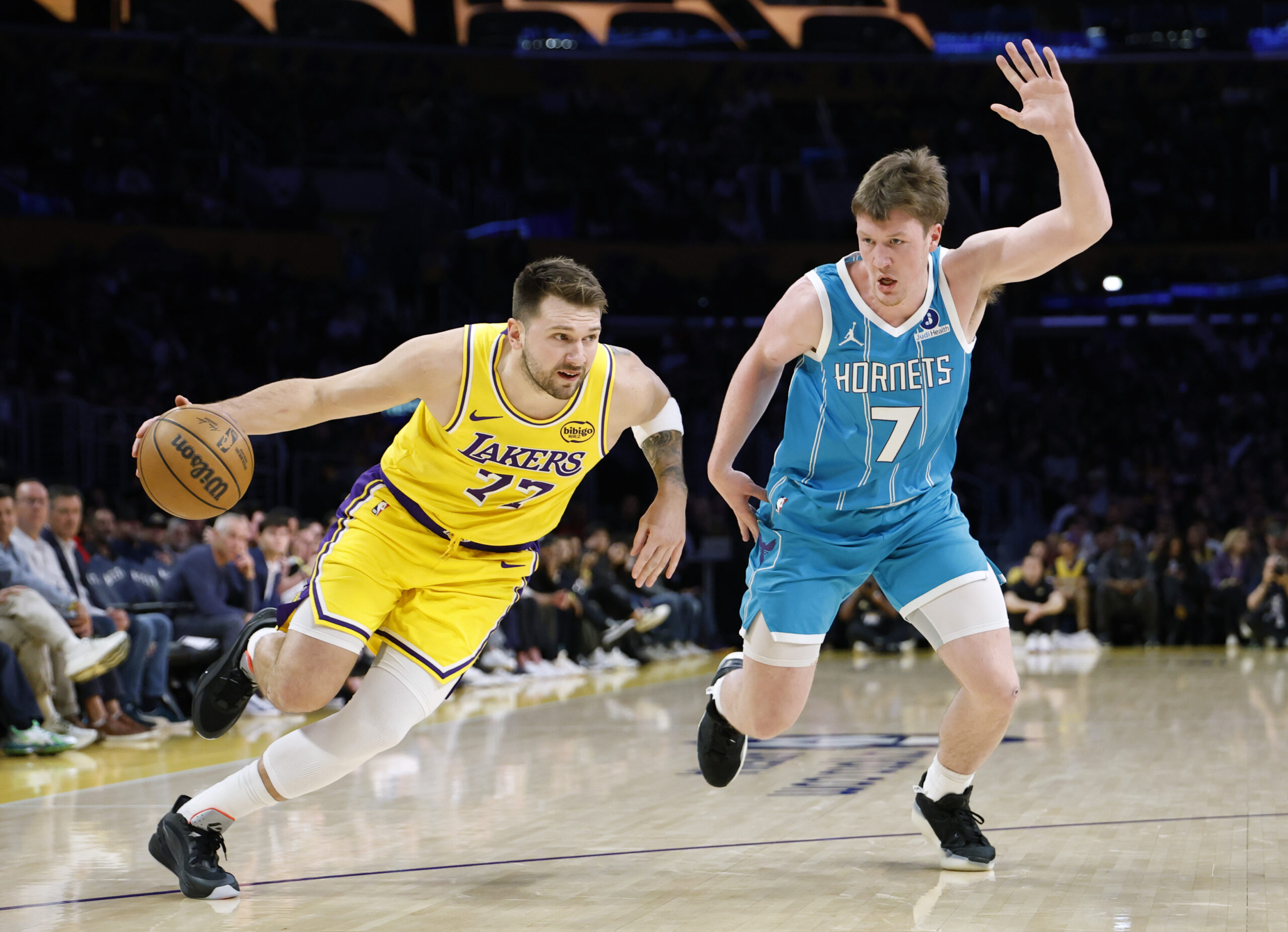 Lakers star Luka Doncic drives to the basket as Charlotte...