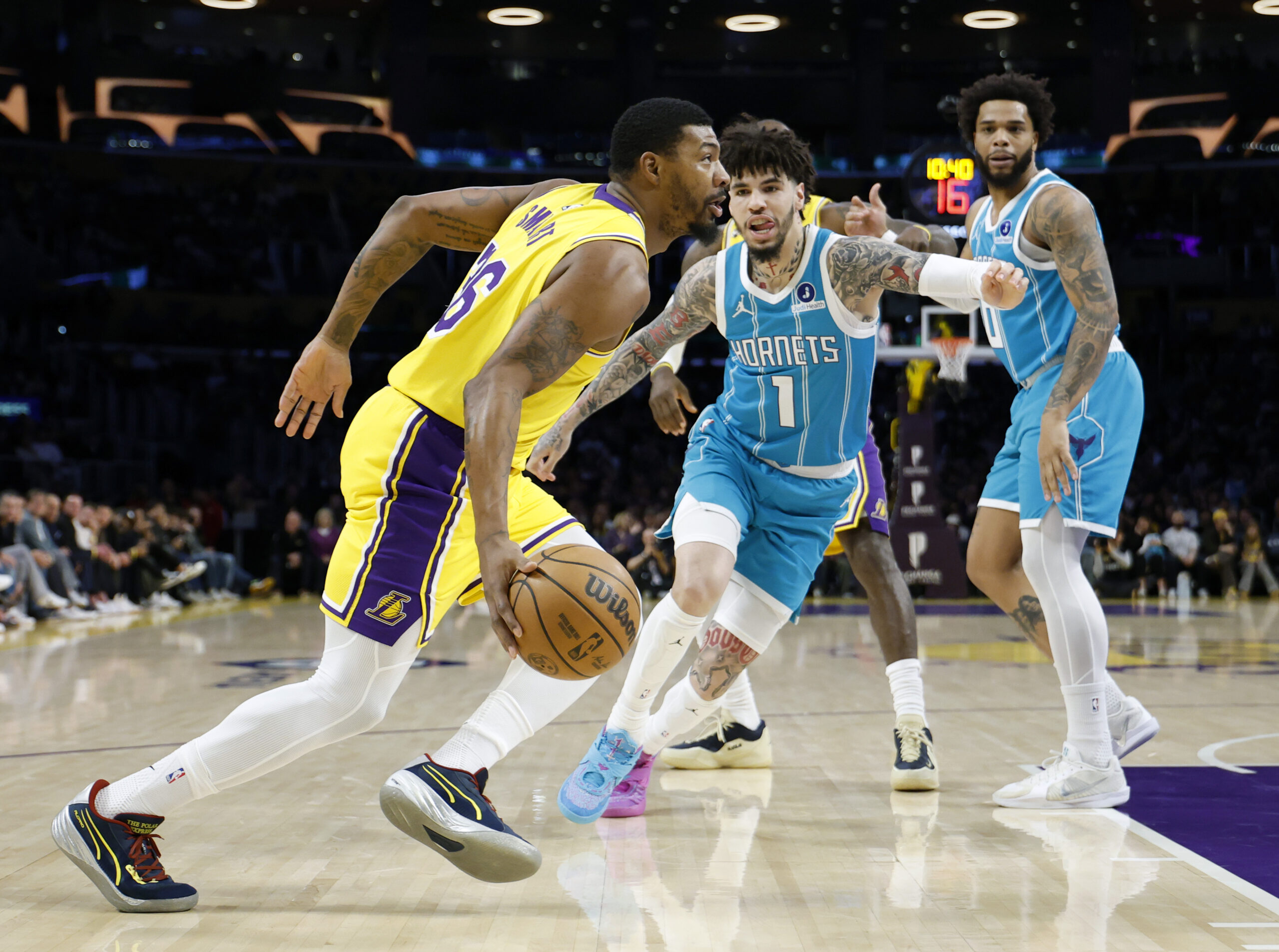 Lakers guard Marcus Smart drives to the basket in front...