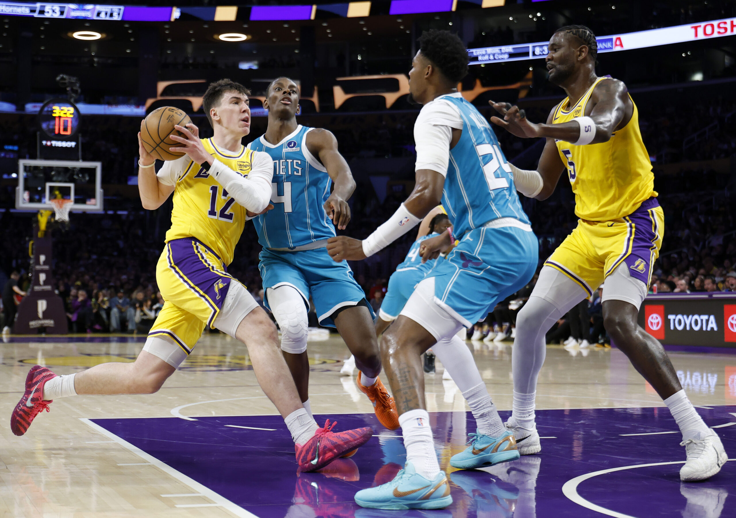 Lakers forward Jake LaRavia, left, drives to the basket in...