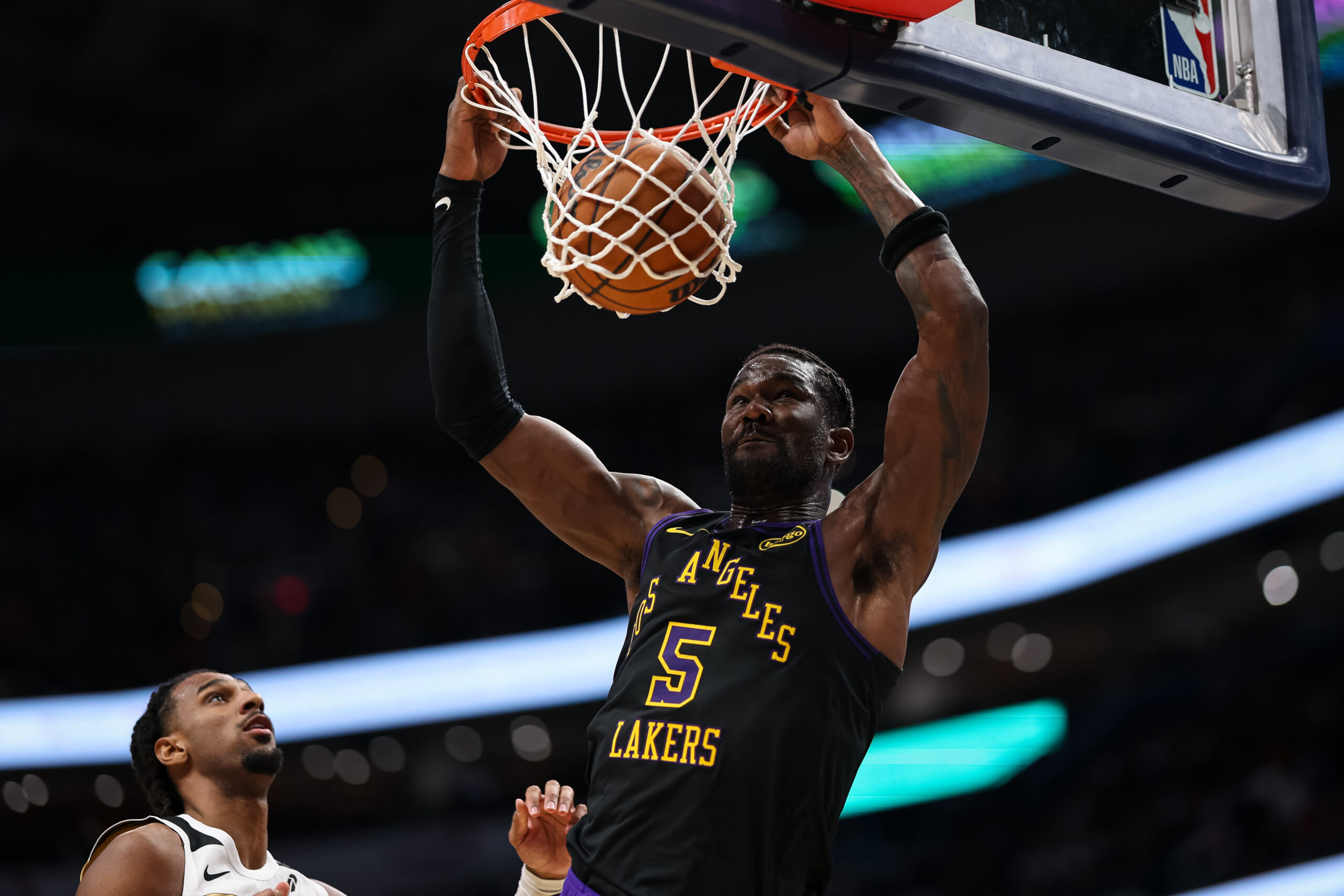Lakers center Deandre Ayton dunks in front of the Washington...