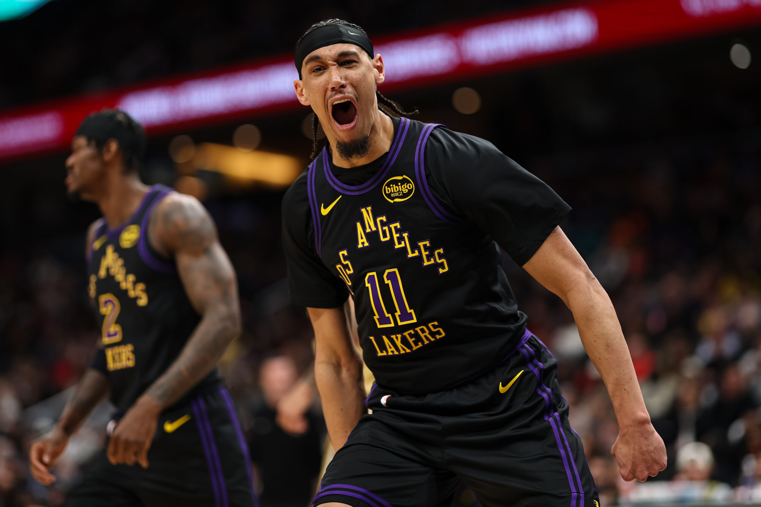 Lakers center Jaxson Hayes celebrates after dunking during the first...