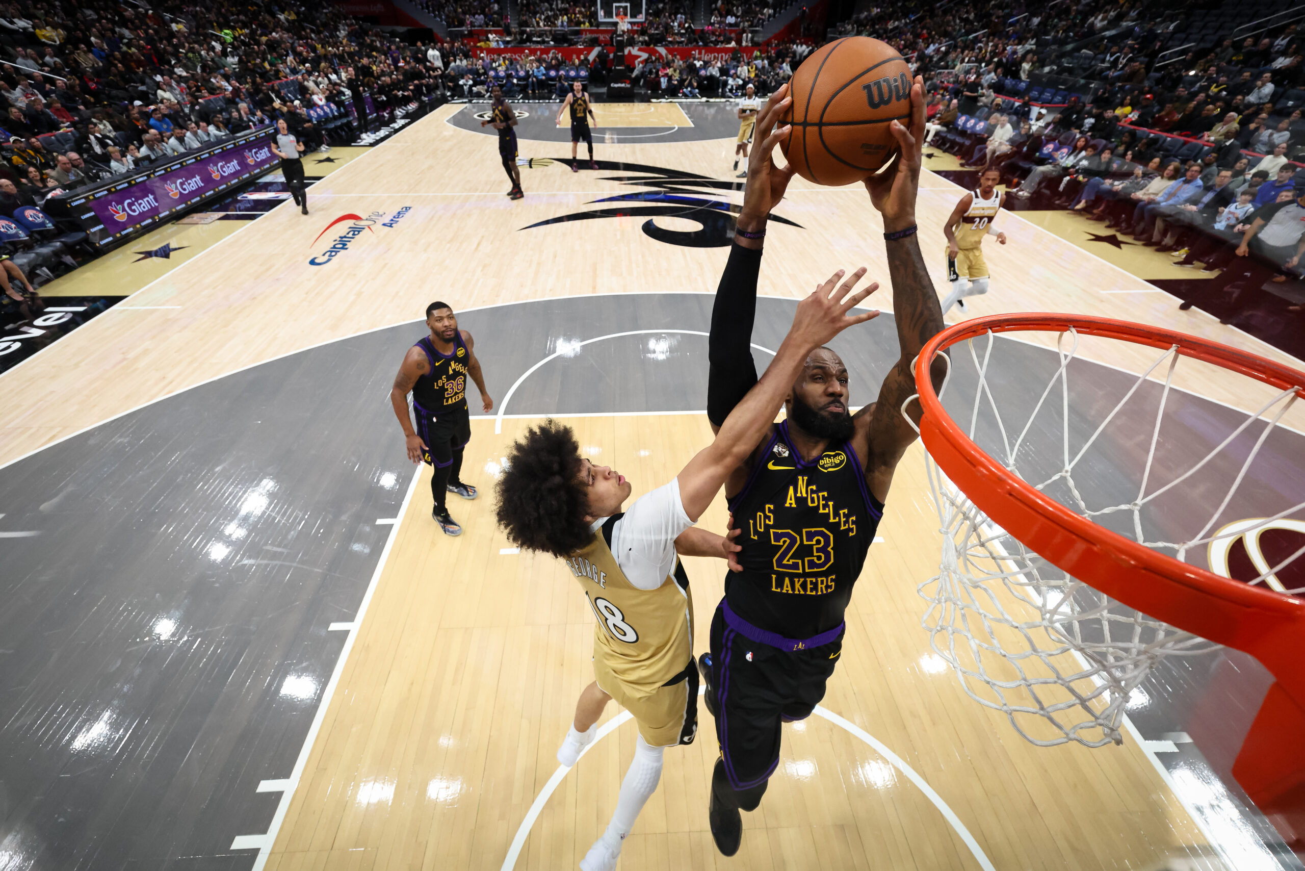Lakers star LeBron James goes up for a dunk as...