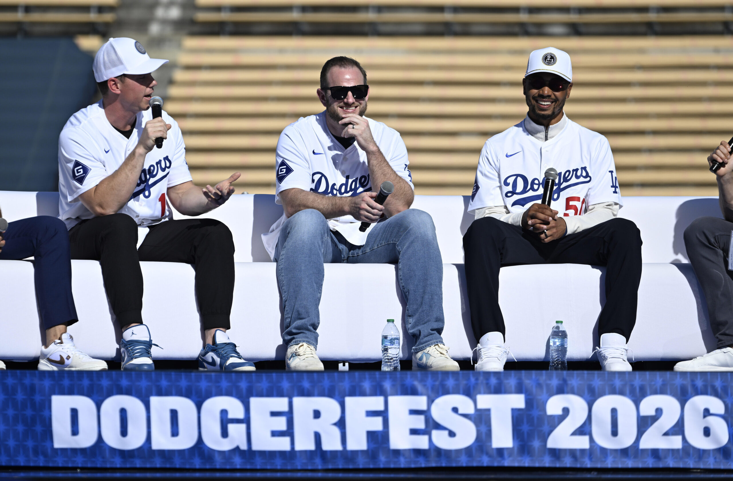 Will Smith, left, speaks as Max Muncy and Mookie Betts...