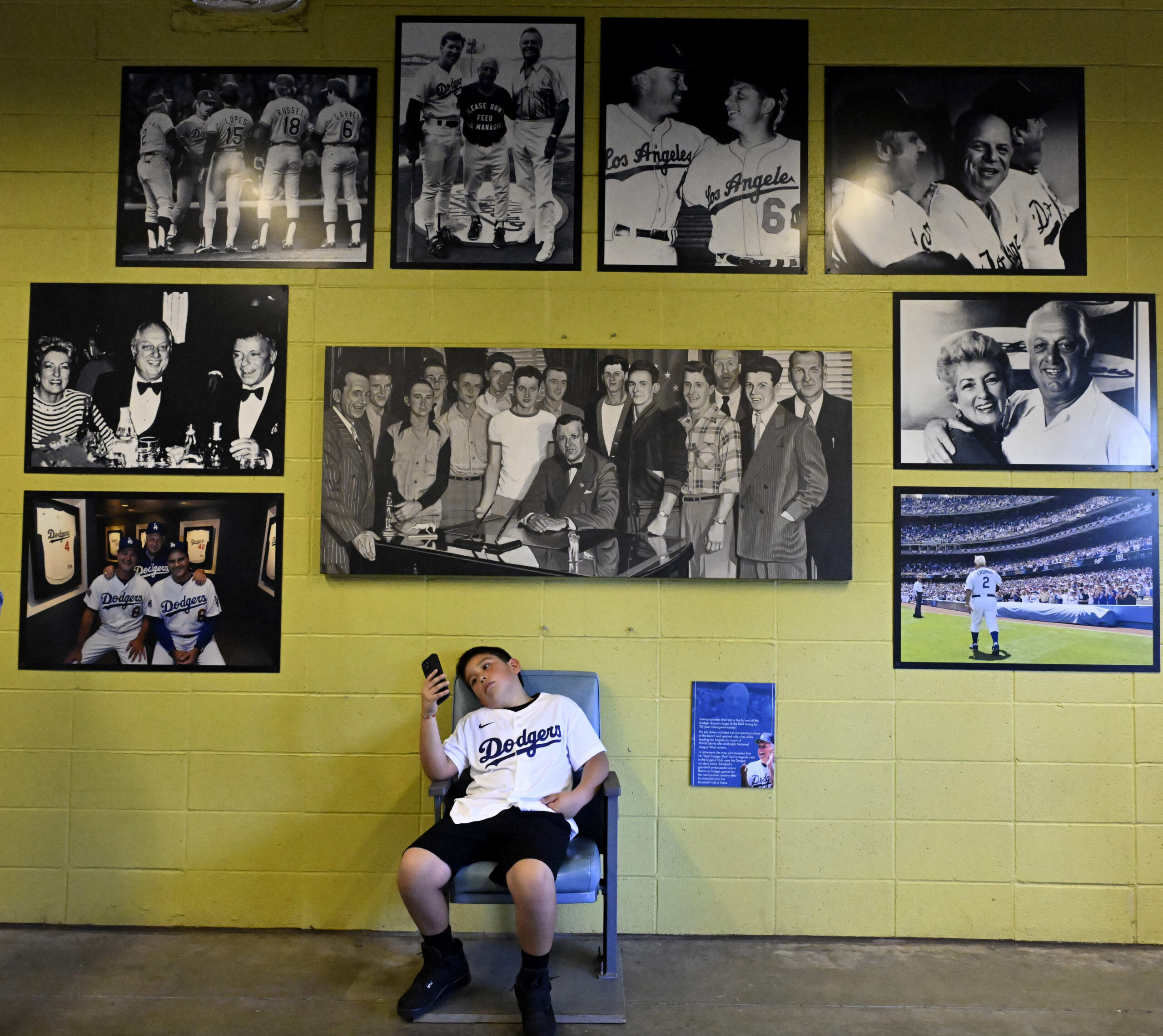 A Dodger fan waits in the shade on a hot...