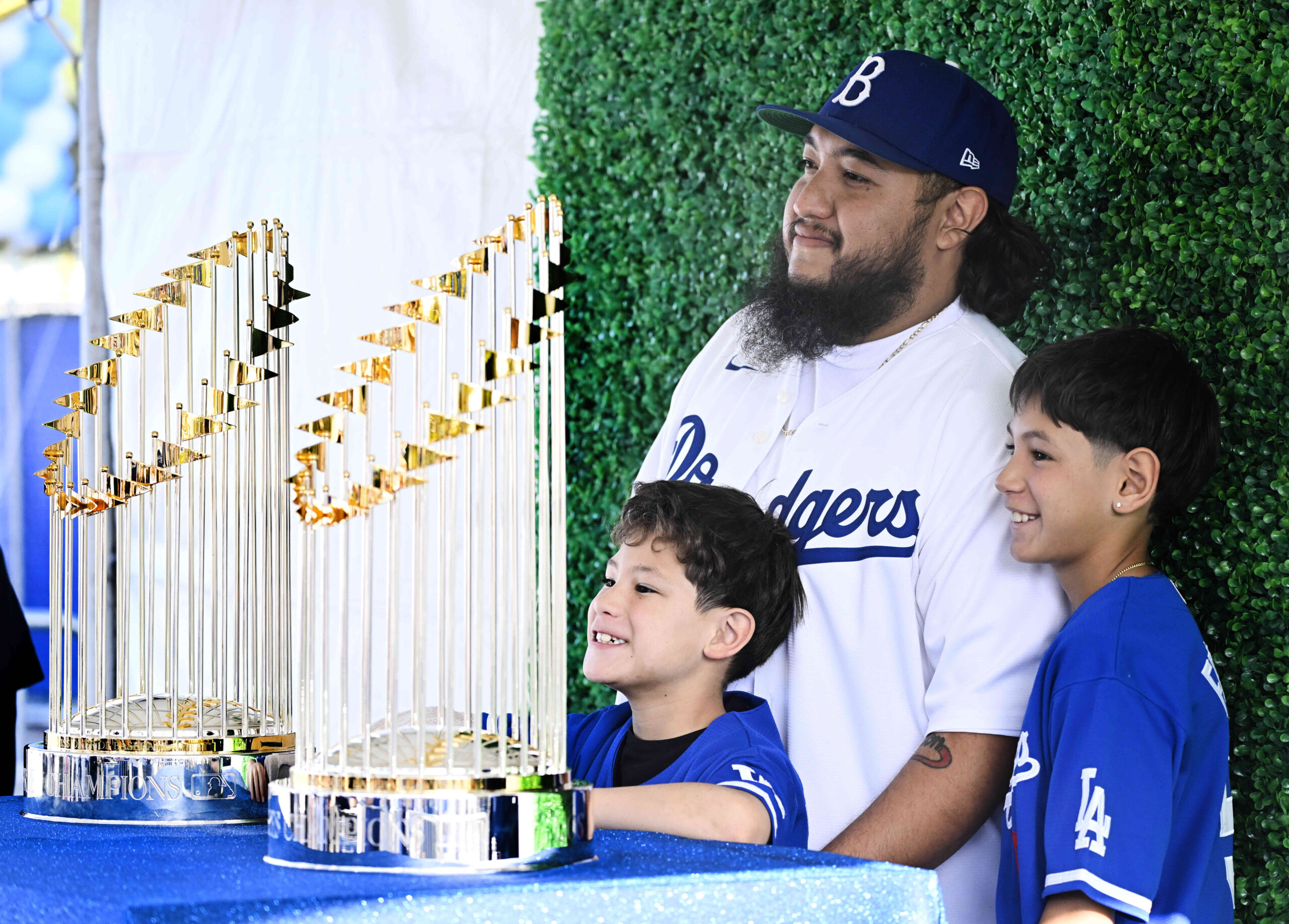 Victor Arvizu, with his sons Dominique, left, and Victor pose...