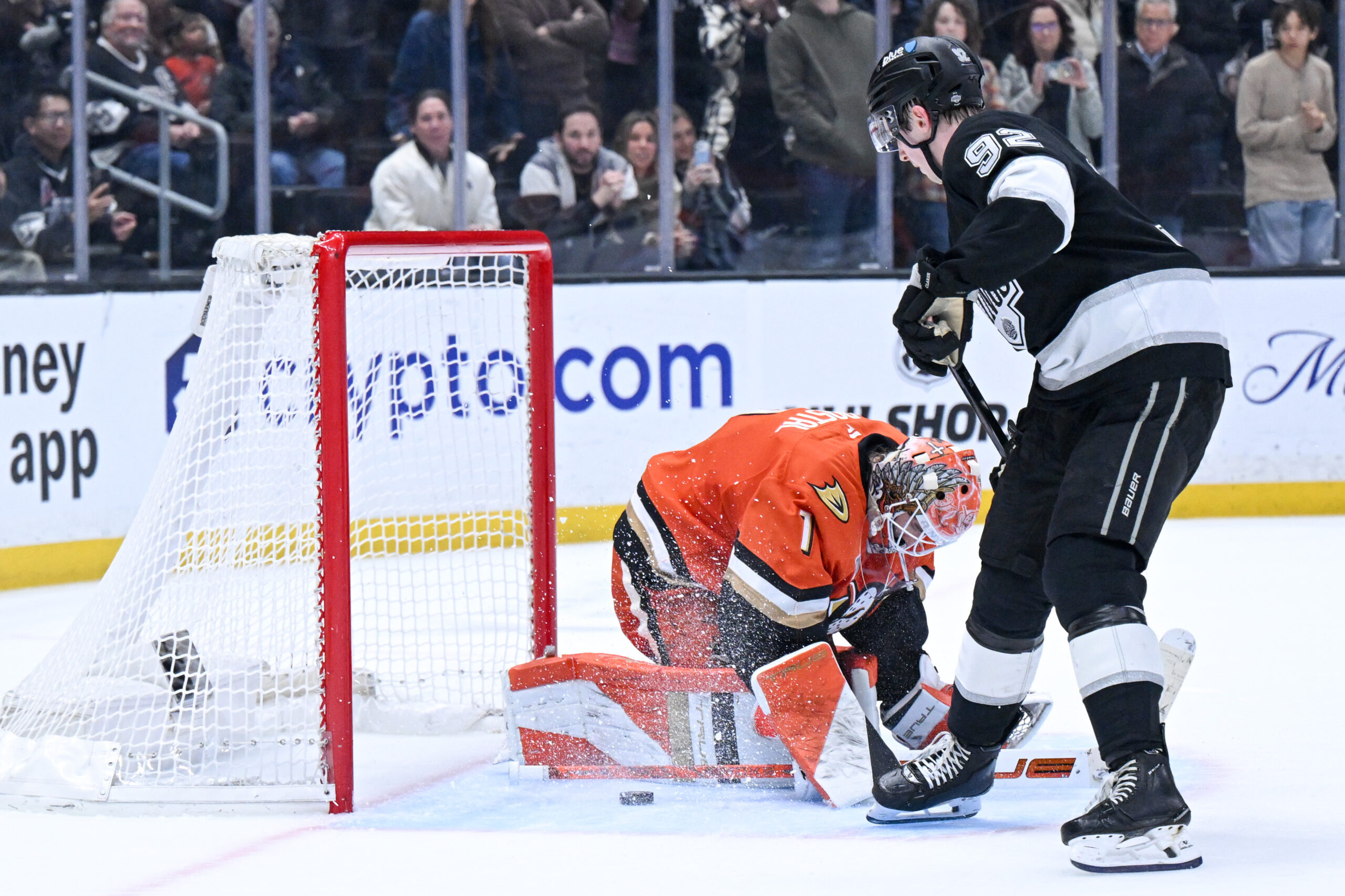 The Kings’ Brandt Clarke (92) scores on Ducks goaltender Lukas...