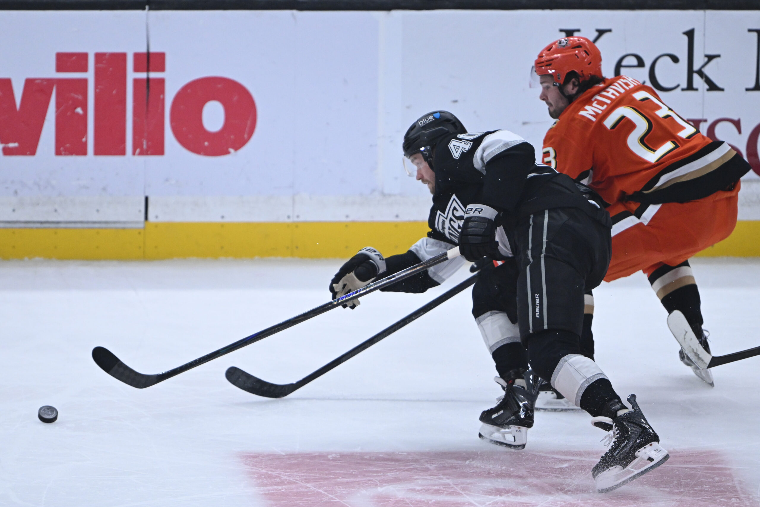 The Kings’ Joel Armia, left, and the Ducks’ Mason McTavish...