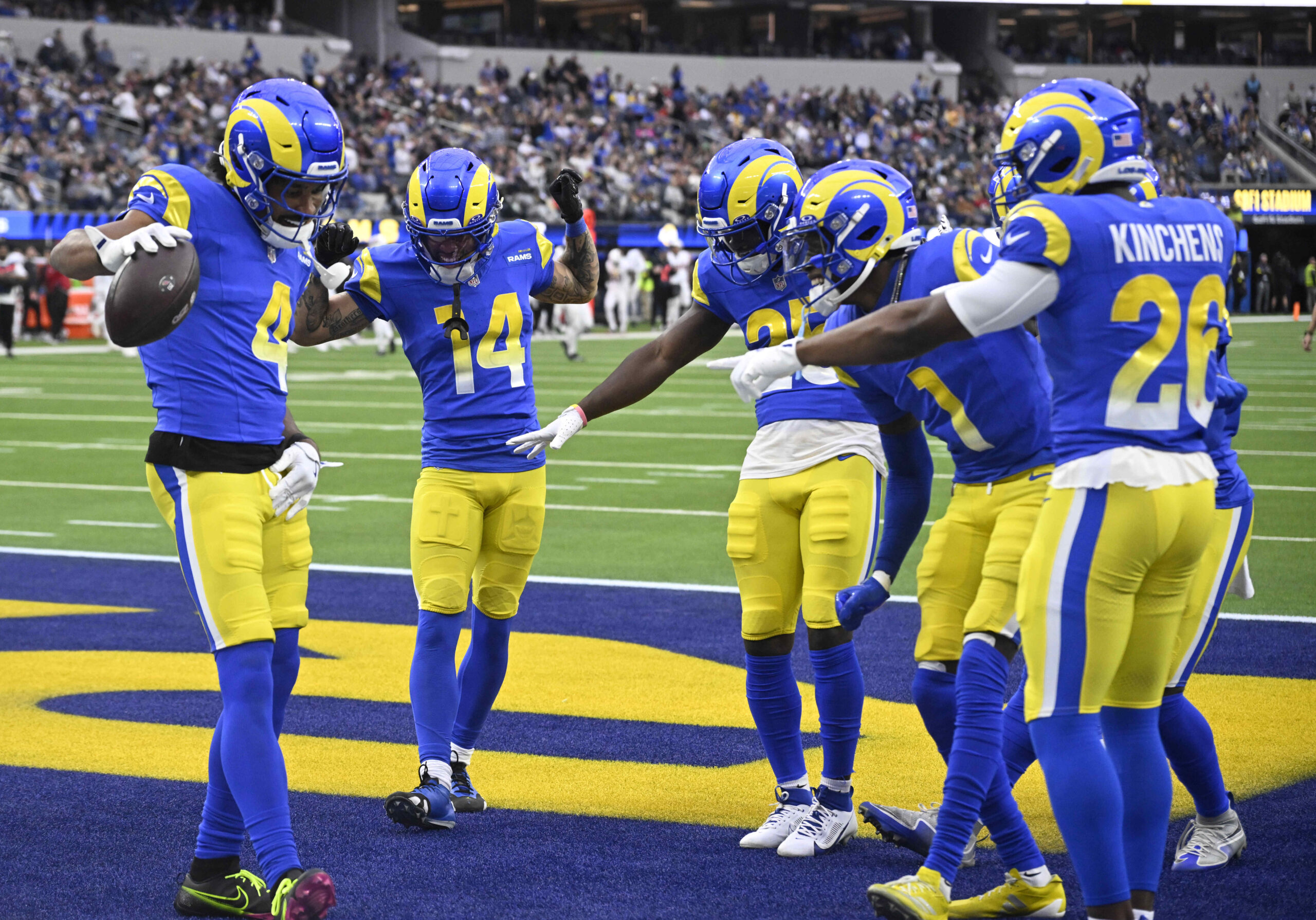 Ahkello Witherspoon #4 of the Rams reacts with teammates after...