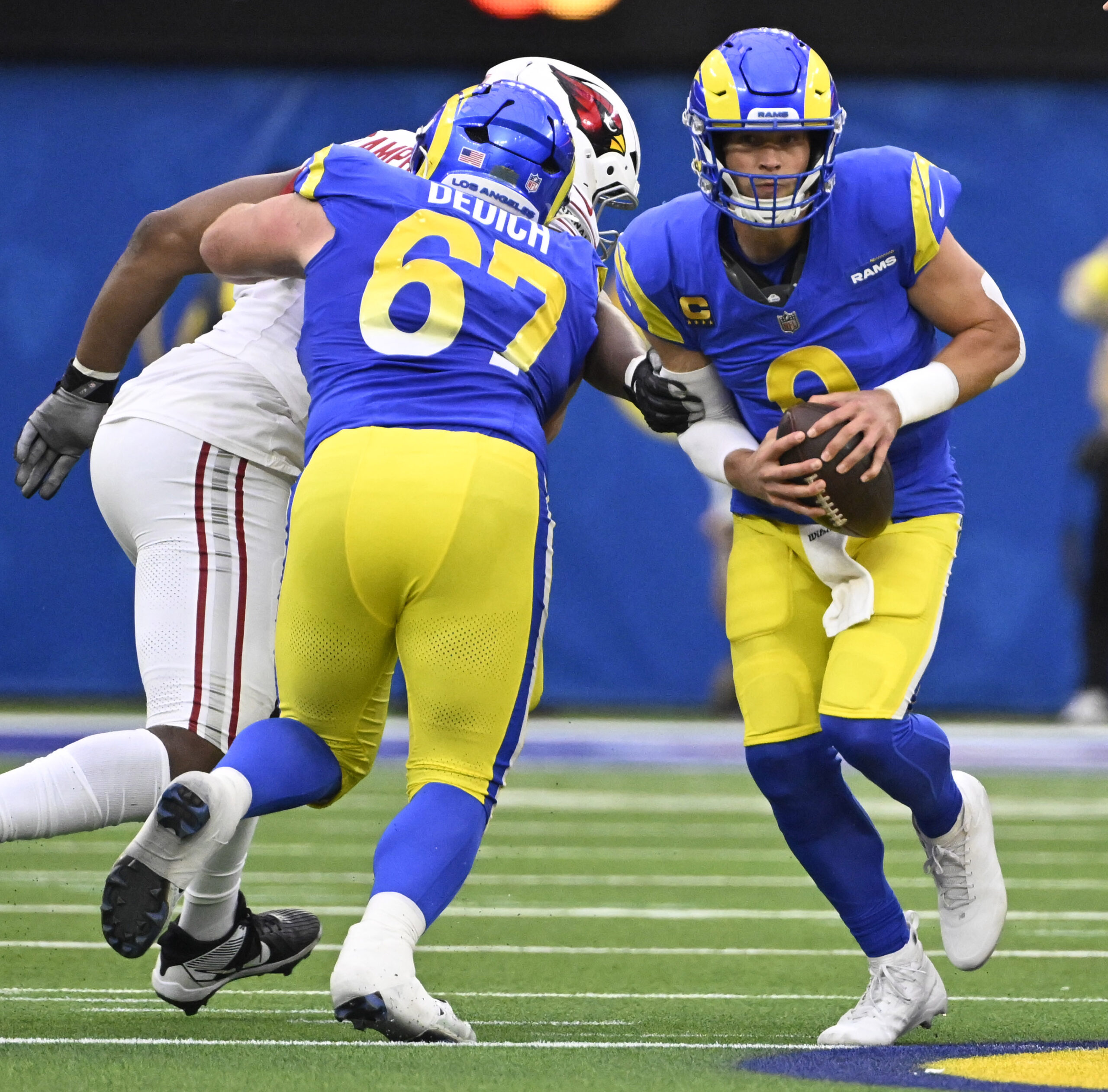 Rams quarterback Matthew Stafford #9 scrambles against the Arizona Cardinals...