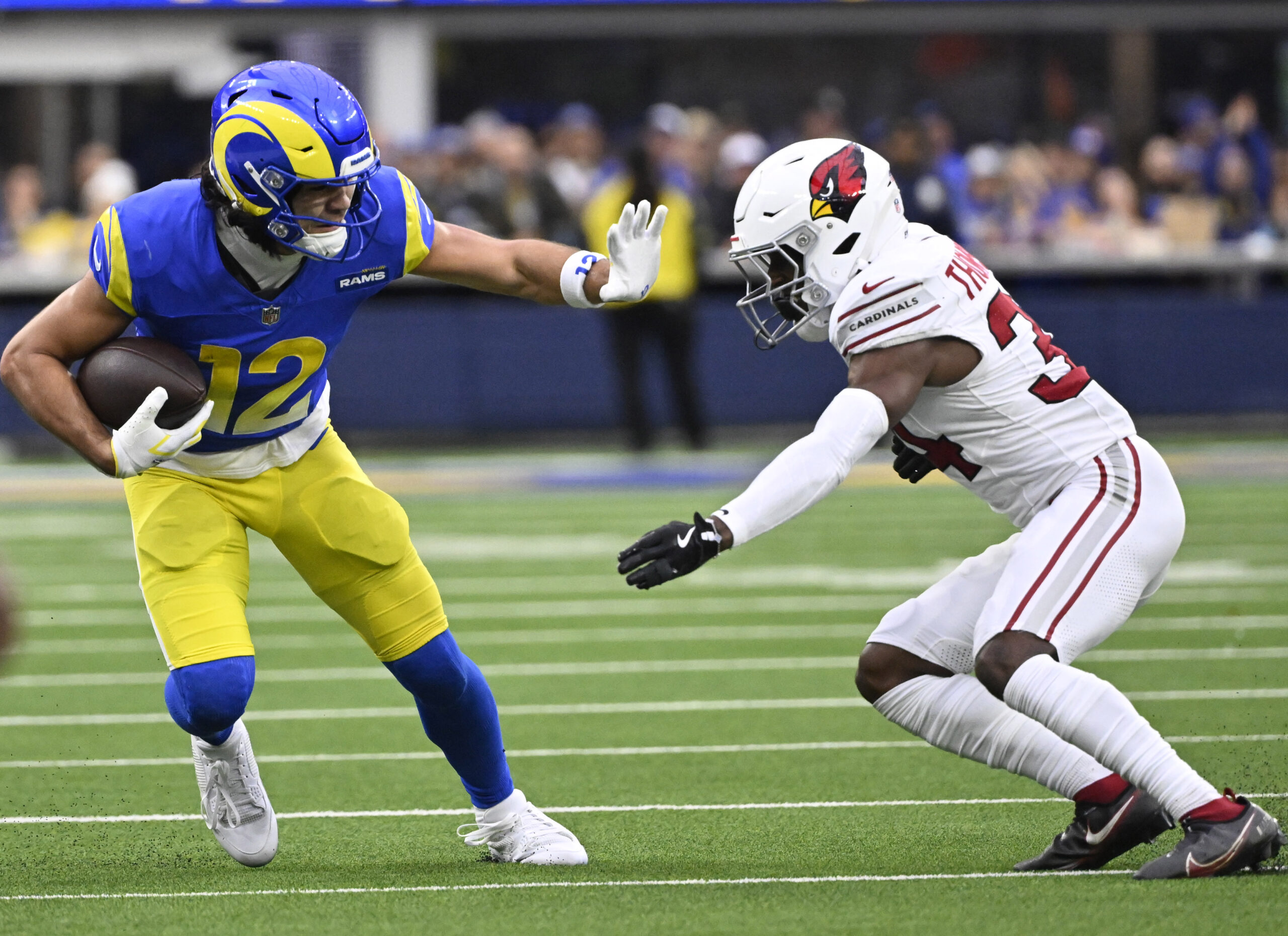 Rams wide receiver Puka Nacua #12 catches a pass for...