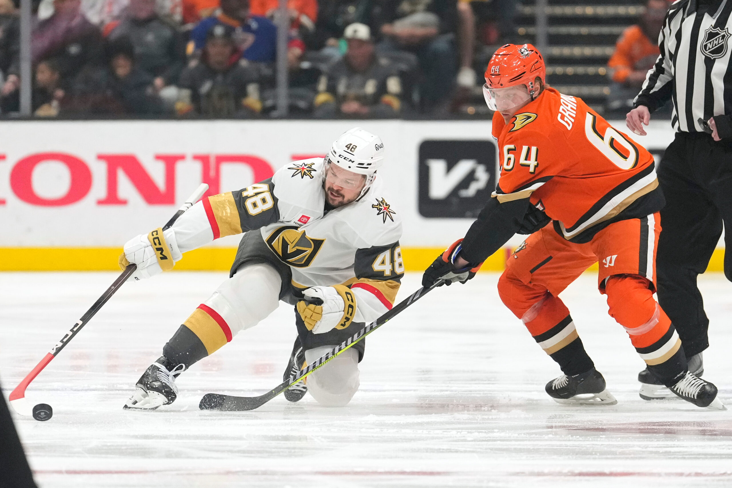 Vegas Golden Knights center Tomas Hertl, left, falls as he...