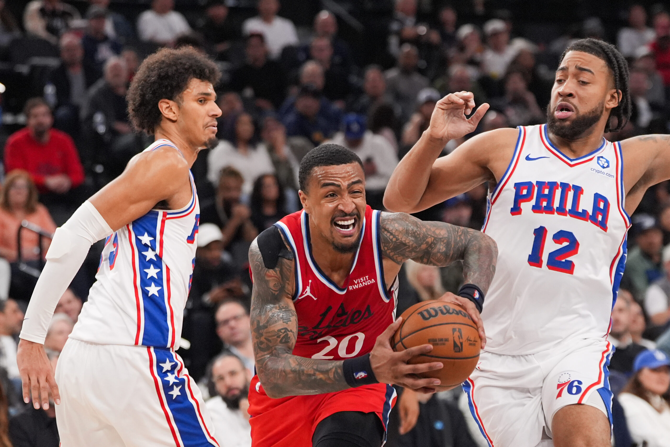 Clippers forward/center John Collins (20) is defended by Philadelphia 76ers...