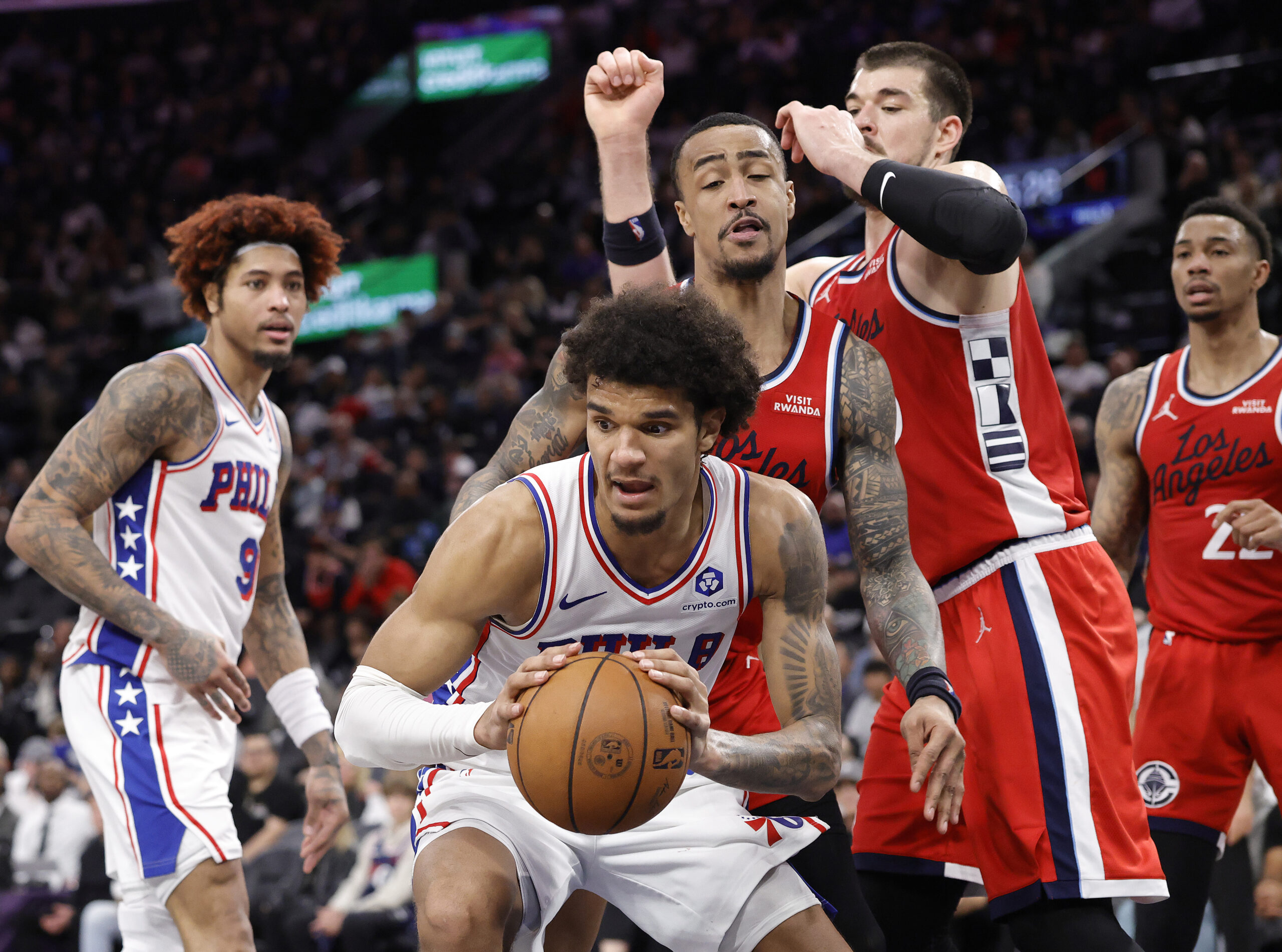 The Philadelphia 76ers’ Dominick Barlow handles the ball in front...