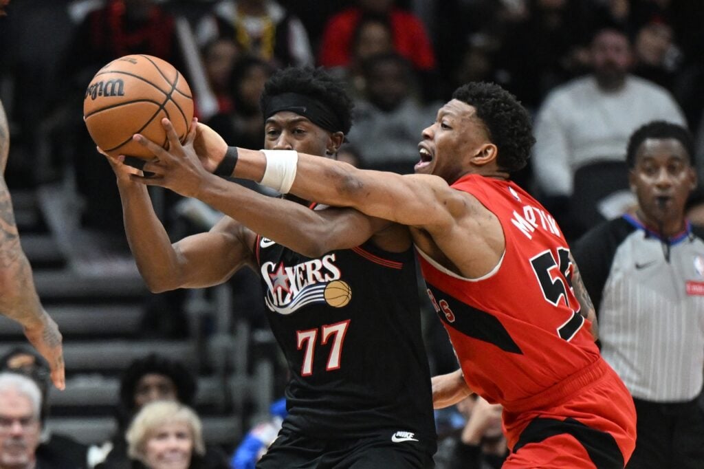 Jan 11, 2026; Toronto, Ontario, CAN; Toronto Raptors guard Alijah Martin (55) forces a turnover by knocking the ball from the grasp of Philadelphia 76ers guard VJ Edgecombe (77) in the second half at Scotiabank Arena. Mandatory Credit: Dan Hamilton-Imagn Images